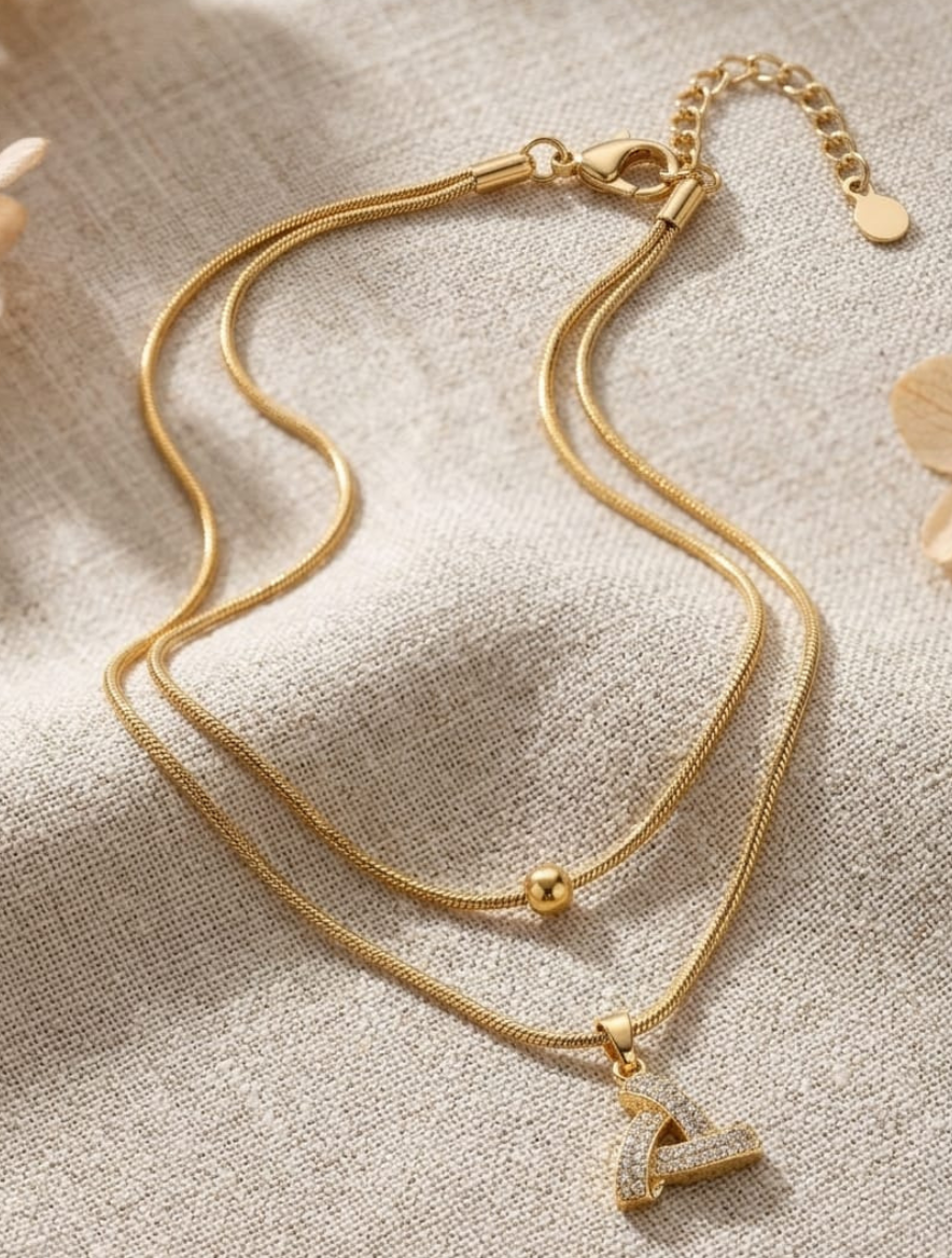 Elegant Dual-Layered Gold-Plated Snake Chain Necklace with Shimmering Interlocked Triangle Diamond Pendant and Minimalist Bead Accent - Image 3