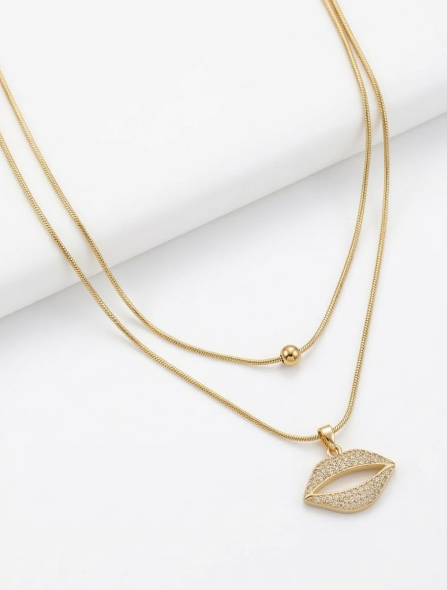 Crystal lips pendant necklace on a gold double-layer snake chain