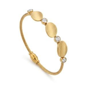 Close-up of a gold twisted cable bangle with three textured oval discs and four sparkling crystals