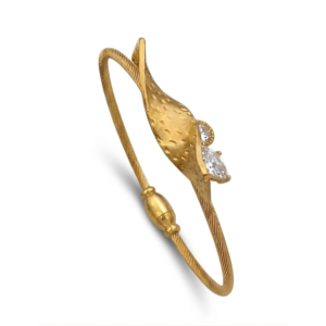 Close-up of a gold hammered organic leaf bangle with pear-cut crystals on a twisted wire cuff