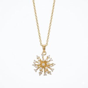 Close-up of a gold Starburst Firework Pendant with sparkling crystal clusters on a cable chain